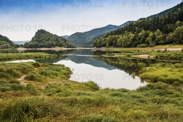 Picturesque mountain lake with water reflections in autumn, Lac de Kruth-Wildenstein, Kruth, Vosges, Alsace-Lorraine, Department of Vosges Haut-Rhin, France