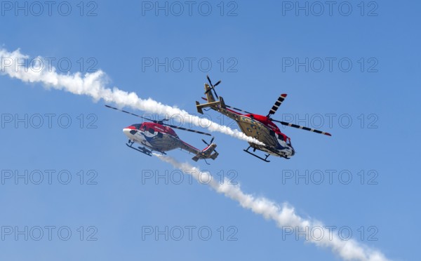 Indian Air Force (IAF) ALH Mk1 Sarang helicopters soar through the sky during an air show as part of the 93rd Air Force Day celebrations on November 8, 2025 in Guwahati, India