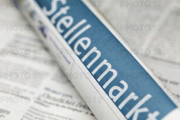 Symbolic image of the labor market in Germany: close-up of a newspaper with the text JOB MARKET