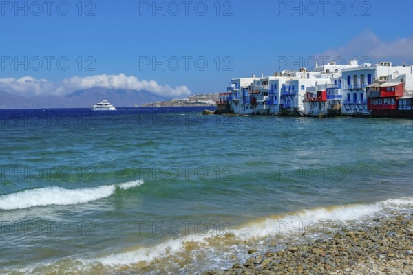 Mykonos, Cyclades, Greece - Little Venice is a picturesque neighborhood in Mykonos Town with colorful houses that stand right by the sea and are reminiscent of Venice. Little Venice is located on Alefkandra Bay next to the famous windmills of Mykonos. Mykonos is part of the Cyclades archipelago in the Aegean Sea