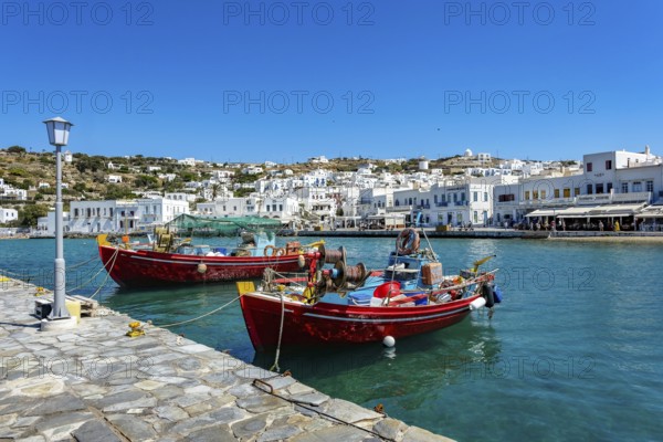 Mykonos, Cyclades, Greece - Colourful fishing boats are moored on the quay in the old port of Mykonos Town, Mykonos Chora. Mykonos is part of the Cyclades archipelago