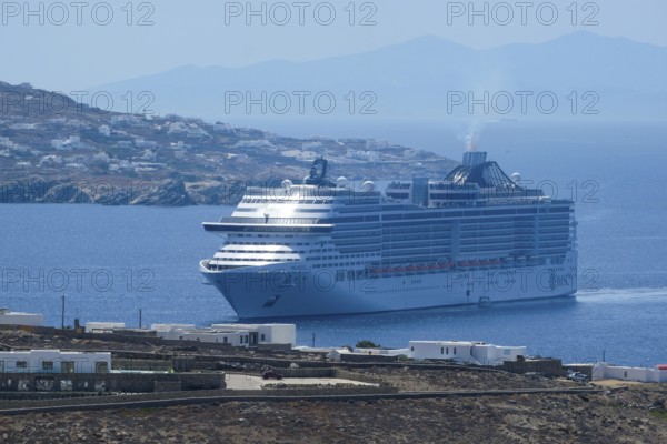 Mykonos, Cyclades, Greece - cruise ship MSC Divina sails to Mykonos harbour bay