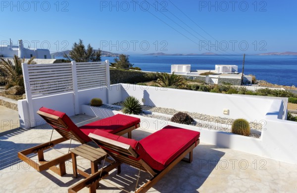Mykonos, Cyclades, Greece - theme photo: vacation in Greece, sun loungers on the terrace of a boutique hotel with sea views