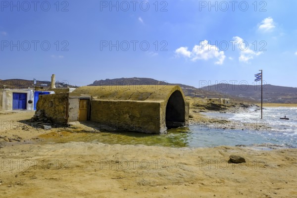 Mykonos, Cyclades, Greece - Ftelia Beach, fishing lodge on Ftelia beach, sandy beach on windy rocky coast in the north of the island