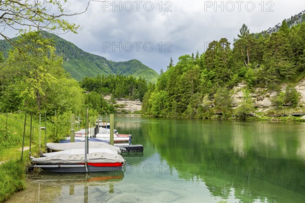 Boats lying on Lake Elisabethsee on a cloudy day in spring, Salzkammergut, Austria