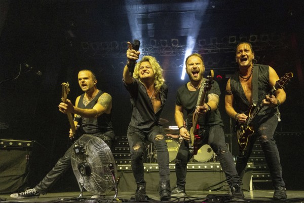 Ande Braun (guitarist), Hannes Braun (singer), Steffen Haile (bassist) and Jim Müller (guitarist) of the band Kissin' Dynamite live on Back with a Bang World Tour at Capitol Hannover on 09.11.2025