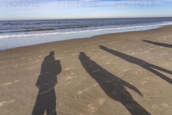 East beach of the East Frisian island of Spiekeroog, shade of walkers on the beach, Lower Saxony, Germany