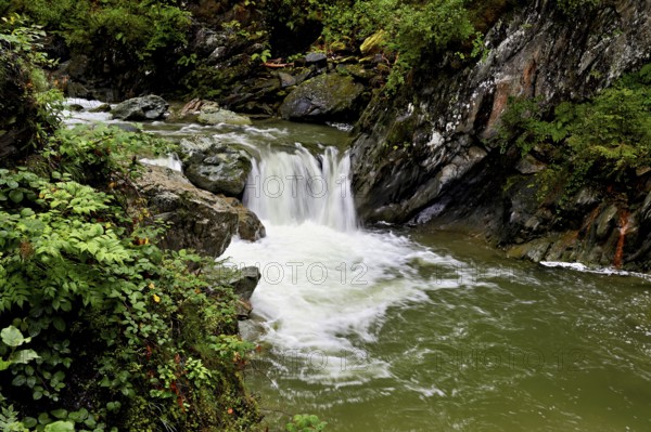 Small waterfall on the Diosaz mountain river in the gorge, Gorges de la Diosaz, Les Houches, Chamonix-Mont-Blanc, Haute-Savoie, France