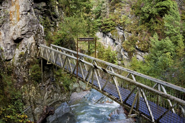 Wooden bridge over the mountain river Diosaz in the gorge, Gorges de la Diosaz, Les Houches, Chamonix-Mont-Blanc, Haute-Savoie, France