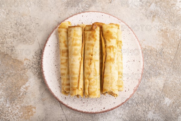 Waffles with caramel on brown concrete background, top view, flat lay, close up