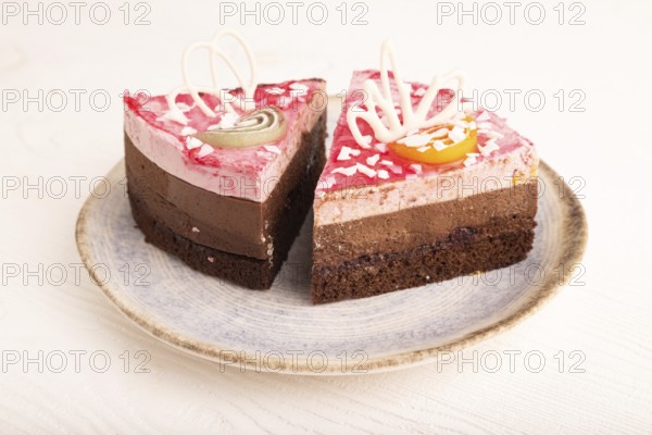 Chocolate cake on white wooden background, side view, close up