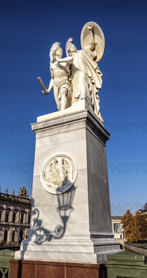 The shadow of a street lamp on the pedestals of the group of figures on the Schlossbrücke, Unter den Linden, Berlin, Germany