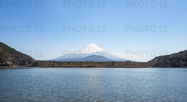 View across the lake to Mt Fuji volcano, Motosu Lake, Yamanashi Prefecture, Japan
