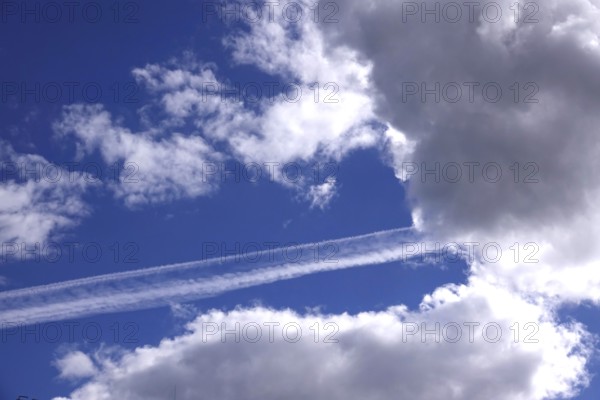 Cloudy sky with contrails, Germany