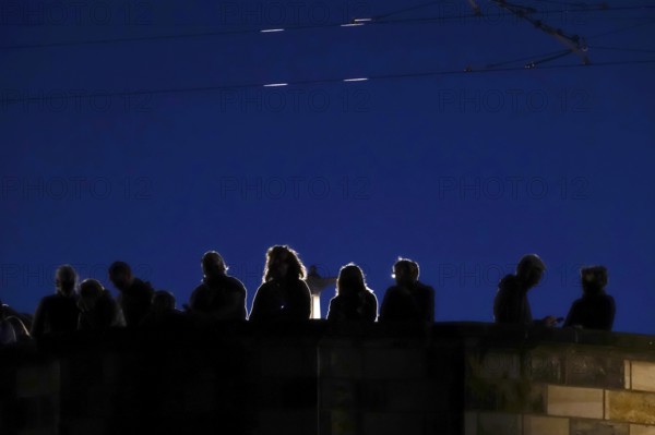 Tourists in Dresden on a bridge in the evening, Saxony, Germany