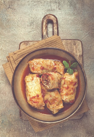 Stuffed cabbage rolls with minced meat, in tomato sauce, top view, without people, in the spotlight