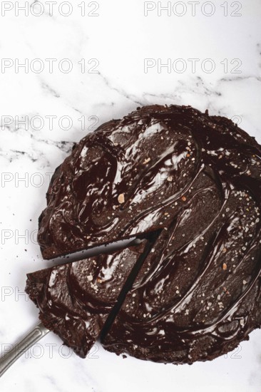 Chocolate cake, round cake, on a marble light table, top view, homemade cakes, no people
