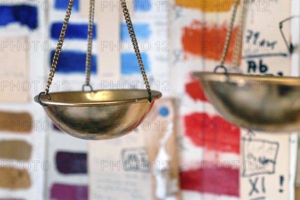 Libra hangs in front of colorful color sample cards in an artist studio, Zurich, Switzerland