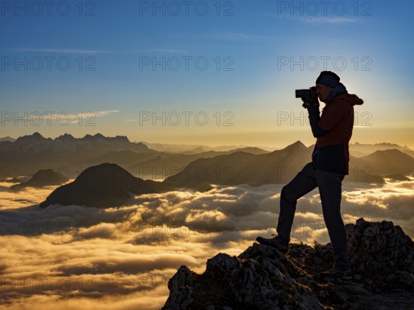 Photographer in evening light at the summit, view of an alpine panorama, Hochstaufen, Chiemgau Alps, Upper Bavaria, Bavaria, Germany