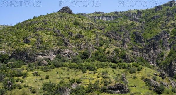 Green hills and rocky landscape under a clear summer sky, landscape near Goris, Hoodoos, Syunik province, Syunik, Armenia