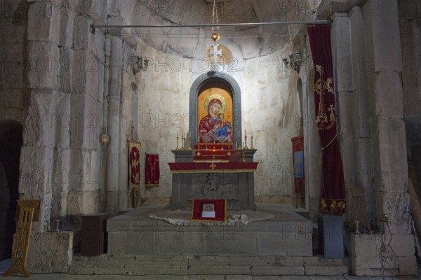 Church altar with icon of the Holy Mother surrounded by candles and religious symbols, Vahanavank Monastery, Syunik Province, Syunik, Armenia
