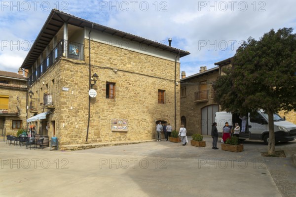 People buying bread from van shop, medieval village of Isuerre, Val d'Onsella, Zaragoza province, Aragon, Spain