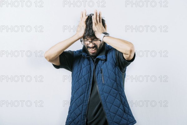 Unhappy man with headache concept. Painful man with a migraine holding his head isolated