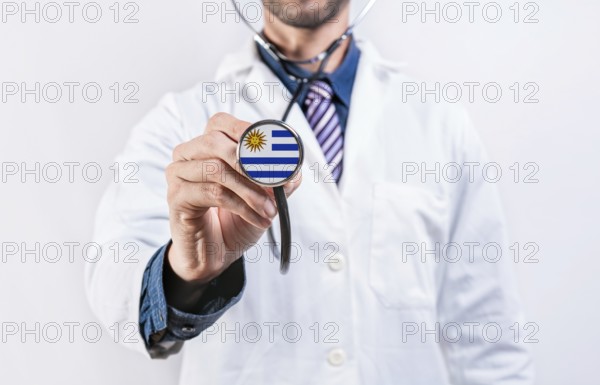 Uruguay healthcare system, doctor holding stethoscope. Uruguay health and medical insurance concept