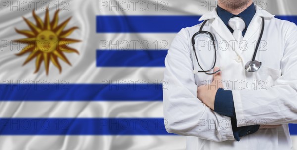 Male doctor with stethoscope on Uruguay flag. Doctor holding stethoscope on Uruguay flag