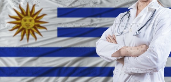 Doctor with crossed arms on Uruguay flag. Uruguay health and care concept. Female doctor on Uruguay flag