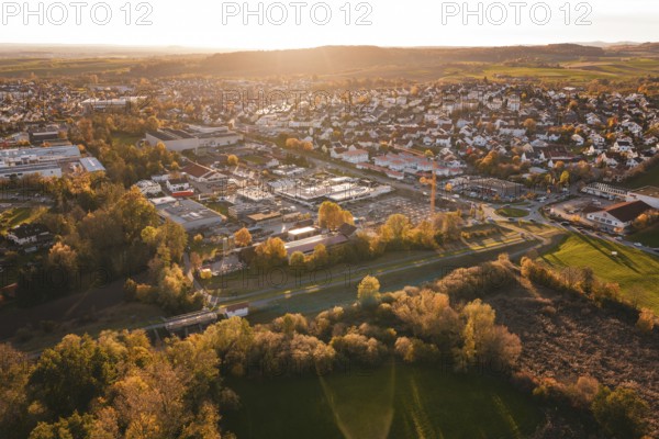 Panorama of a city with residential areas and autumn landscape in evening light, Grossbottwar, Germany