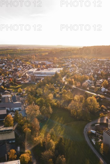 View of small town with lots of trees and autumn light at sunset, Grossbottwar, Germany