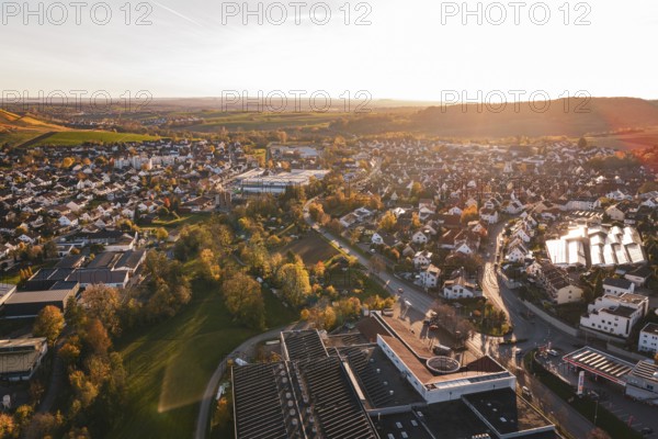 View over the rooftops of a city in autumn evening with lots of nature, Grossbottwar, Germany