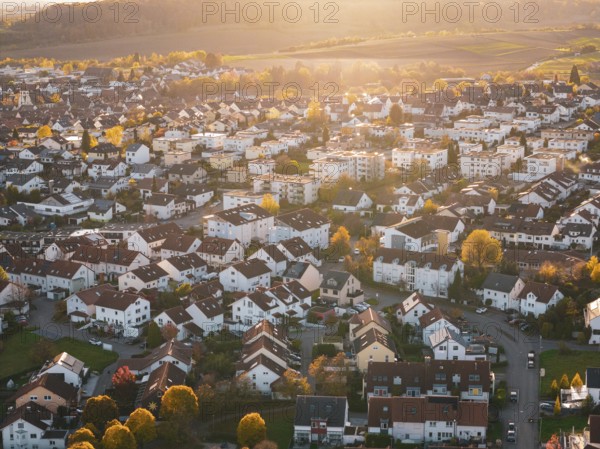 Dense residential area with autumn colors and festive sunset light, Großbottwar, Germany