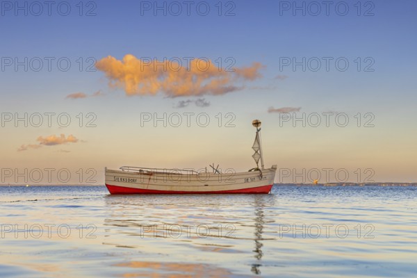Wooden fishing boat anchored in the Bay of Lübeck, Lübecker Bucht in front of Sierksdorf at sunset, Ostholstein, Schleswig-Holstein, Germany