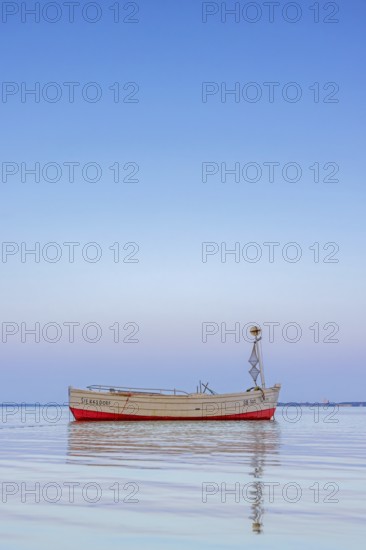 Wooden fishing boat anchored in the Bay of Lübeck, Lübecker Bucht in front of Sierksdorf at sunset, Ostholstein, Schleswig-Holstein, Germany