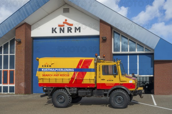 KNRM Mercedes-Benz Unimog 435 truck in front of sea search and rescue lifeboat station at Westkapelle, Zeeland, Netherlands