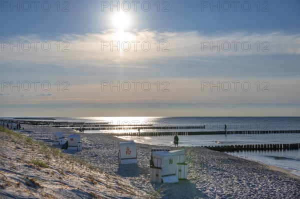 Grooches in the Baltic Sea and beach chairs, the sun against light, Ahrenshoop, Darß, Mecklenburg-Western Pomerania, Germany