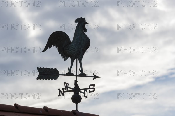 Weathercock silhouette against cloudy sky, looks mysterious, Baden-Württemberg, Germany