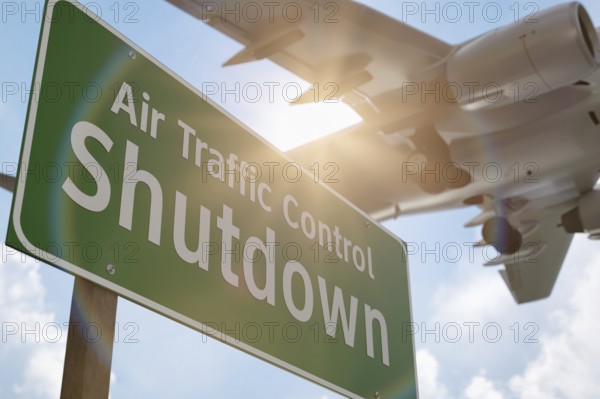 Air traffic control shutdown green road sign with airplane above
