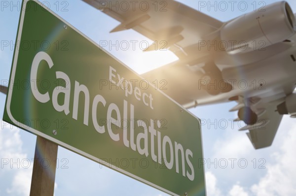 Expect cancellations green road sign with airplane above