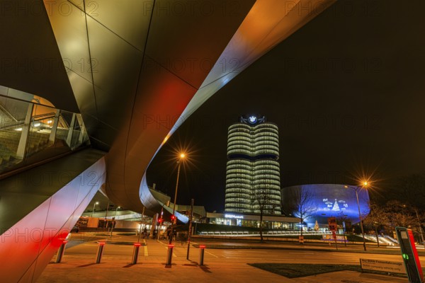 Federally illuminated BMW world, in the back the BMW Museum and the high-rise office building of the BMW headquarters, Petuelring, Munich, Upper Bavaria, Germany