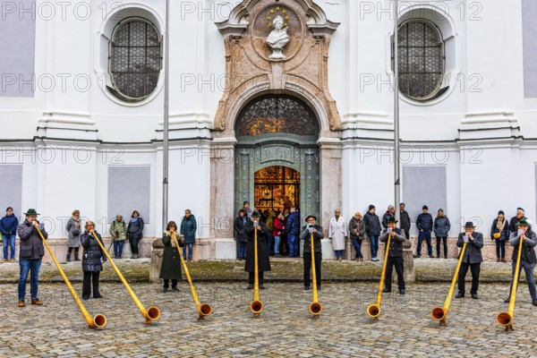 Alphorn group playing in front of Marienmünster in Dießen am Lake Ammer, Upper Bavaria, Bavaria, Germany