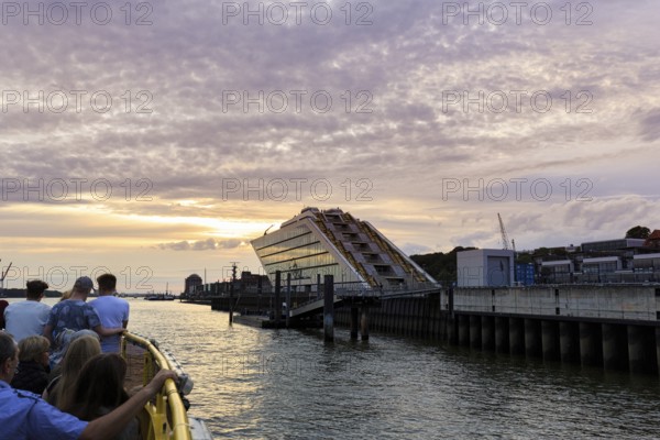 Harbour ferry line 62 with passengers on the Elbe, harbour cruise at sunset, Docklands, Hamburg, Germany