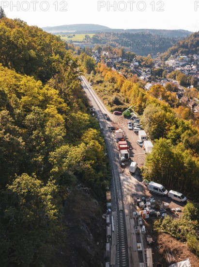 Construction site next to railroad tracks in an autumn landscape with a view of a village, Bau der Hermann, Hesse, Bahn, Calw, Germany