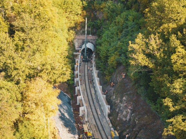 Tunneling for railroad tracks in an autumn forest area with construction workers and machines, construction of Hermann, Hesse, Bahn, Calw, Germany