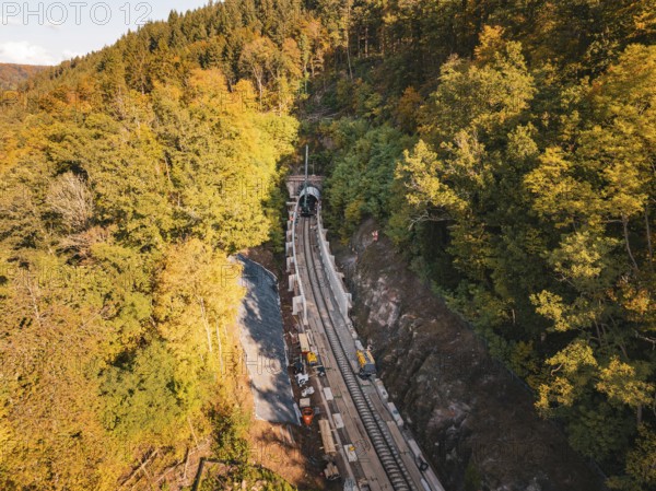 Layered view of an autumn rail construction site in the forest with construction vehicles, construction of Hermann, Hesse, Bahn, Calw, Germany