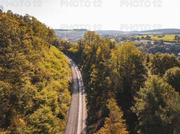 Autumn landscape with railroad tracks and trees, view of hills, building of Hermann, Hesse, railway, Calw, Germany