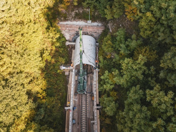 Aerial view of a tunnel boring machine working in a wooded area on a railroad track, built by Hermann, Hesse, Bahn, Calw, Germany