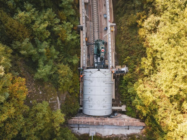 Crane photographed from the air above a tunnel opening in an autumnal landscape, building of Hermann, Hesse, Bahn, Calw, Germany